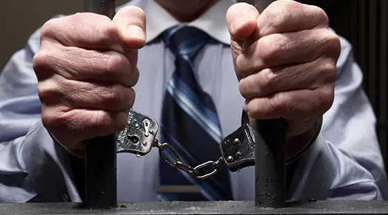 Hands breaking free from handcuffs symbolizing 24-hour bail bond services.