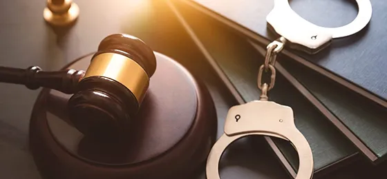 Gavel and handcuffs representing experienced private investigator services in Red Bank, SC