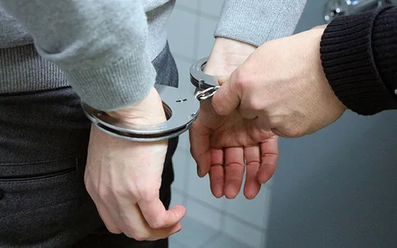 Hands of a person in handcuffs, representing fast and professional bail bond services in Forest Acres, SC.