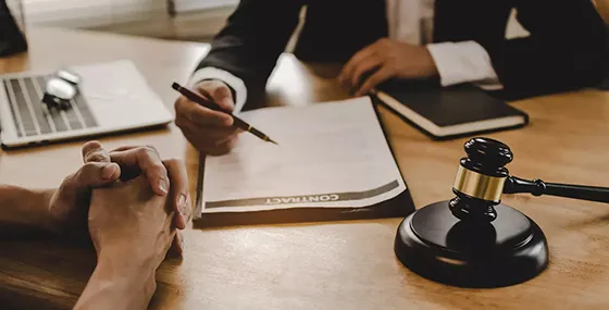Professional signing documents with a gavel, symbolizing reliable bail bonds services in Gaston, SC