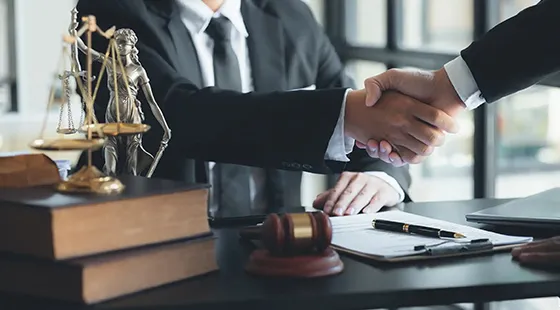 Lawyer shaking hands with a client highlighting benefits of choosing bail bonds services in Archer Lodge, NC