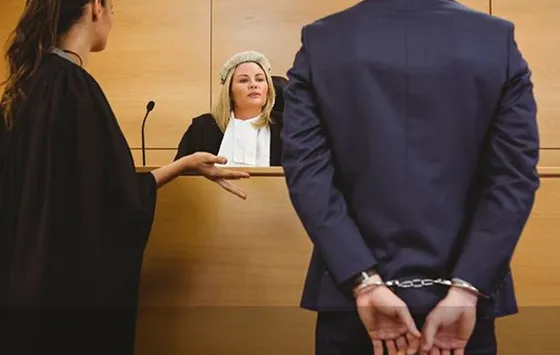 Judge in a courtroom with a person in a suit, representing local bail bonds services in Archer Lodge, NC