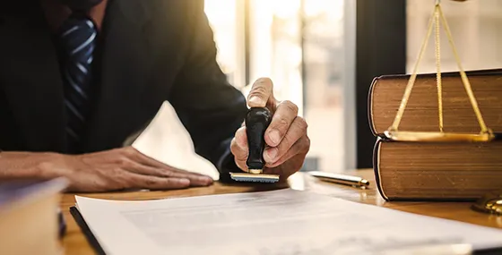 A professional signing documents, representing fast and confidential bail bond approvals in Columbia, SC.