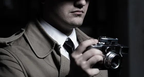 Private investigator holding a camera, highlighting top-rated investigative services in Hopkins, SC with professionalism and discretion.